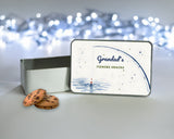 Personalised fishing treat tin for Grandad or Dad with the lid standing upright beside the open tin and biscuits, watercolour rod and float design