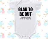 a white baby bodysuit that says glad to be out was running out of wo