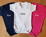 three baby onesuits with the words white, pink, and blue on them