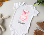 a white bodysuit with a picture of a pig on it